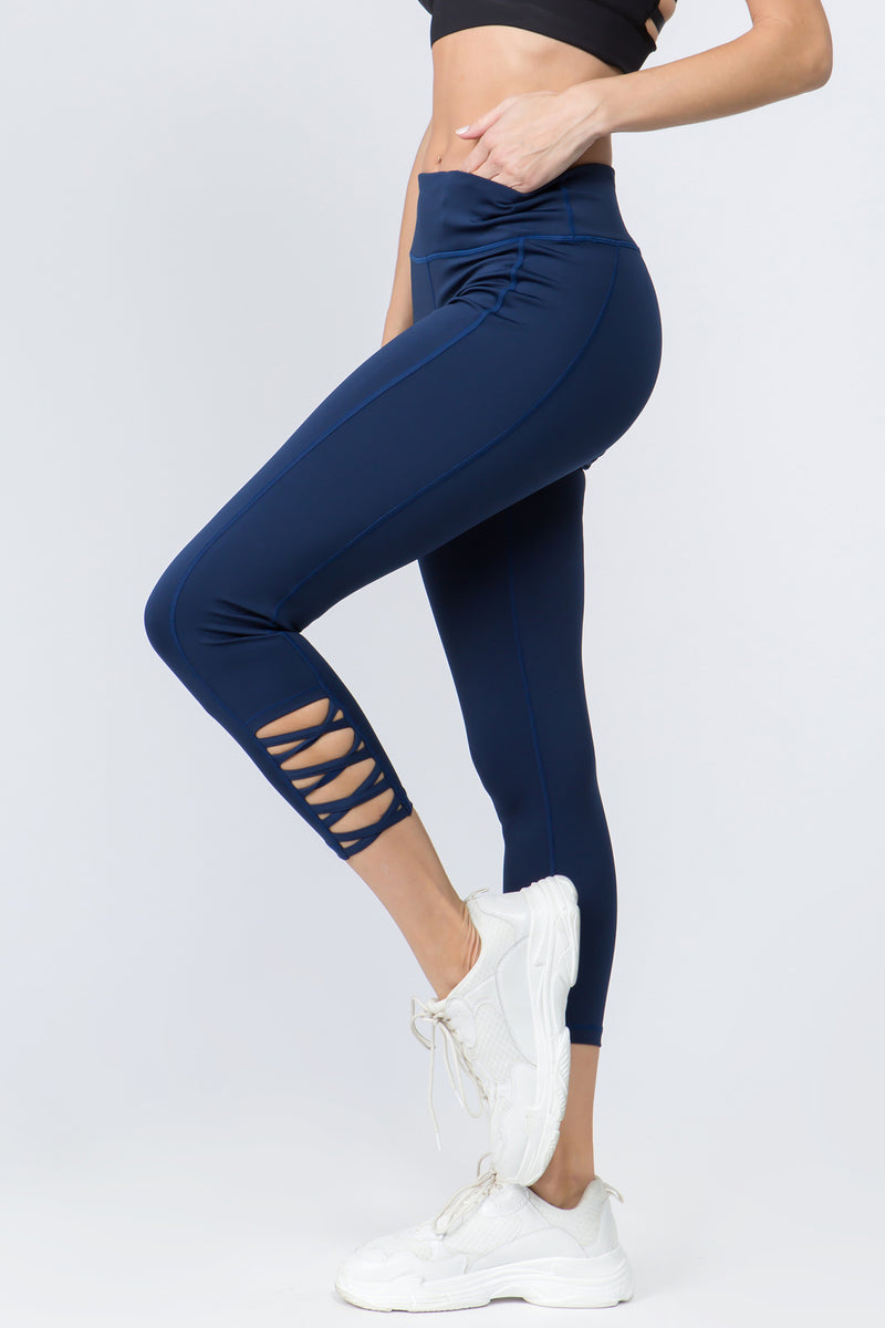 High rise ankle athletic leggings with mesh and crisscross details. Inseam  approximately 23 in length. • Flat high rise waistband with hidden pocket  • 4 way stretch fabric for a move-with-you feel •